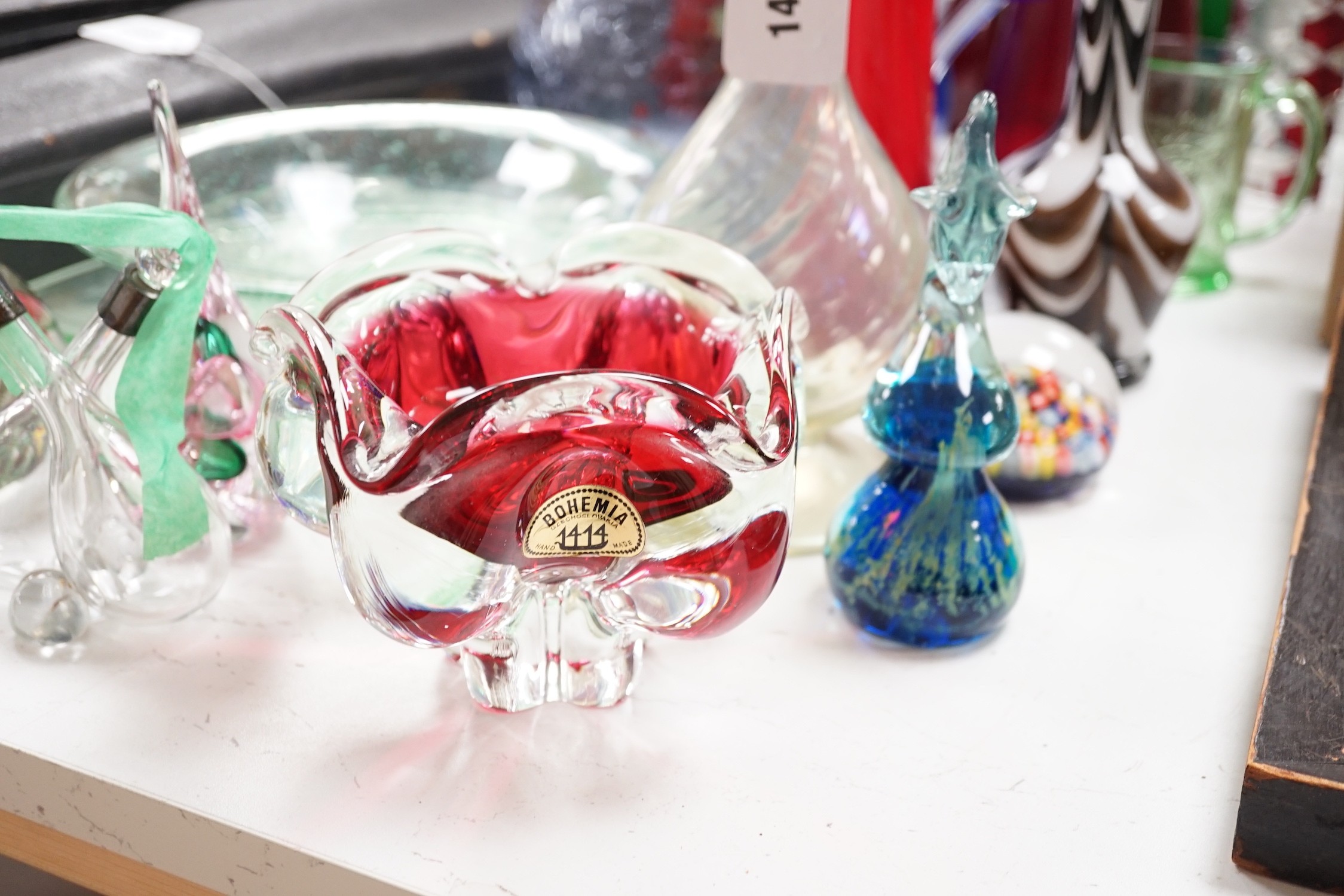 A large group of mixed art glass and other coloured glass vases, bowls, paperweights and two stoppered bottles etc, tallest 65cms high
